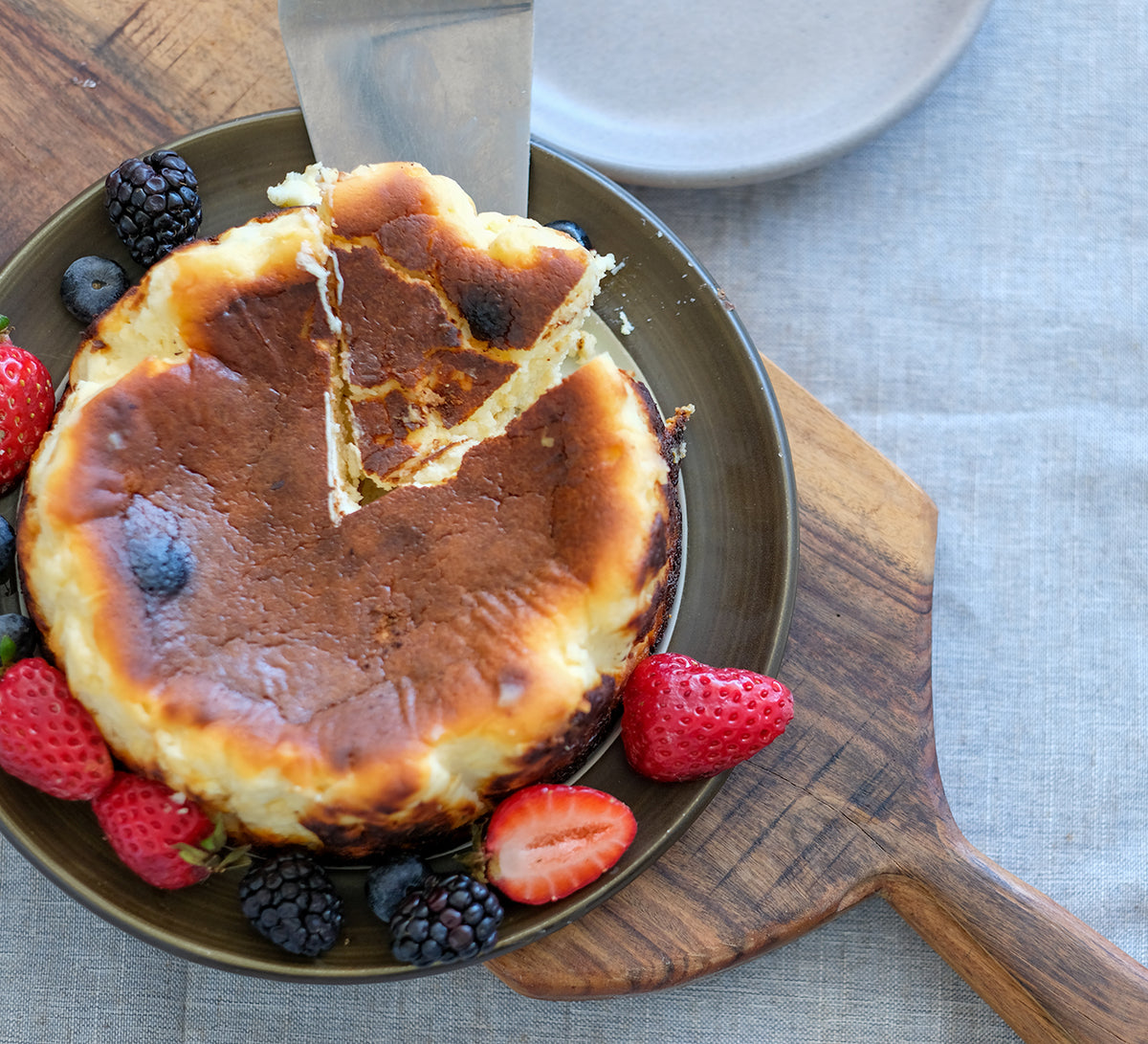 Basque cheesecake seen from above, being served